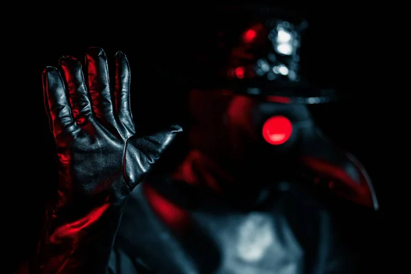 Man in plague doctor costume with crow-like mask disapproving with NO hand sign gesture. Denying, rejecting, disagree isolated on black background. Creepy mask, historical costume concept. Epidemic — Stock Photo, Image