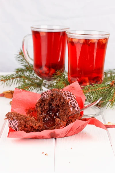 Cupcakes with chocolate cream and red floral tea — Stock Photo, Image