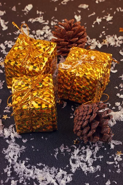 Christmas gift boxes with spruce twigs and cones — Stock Photo, Image