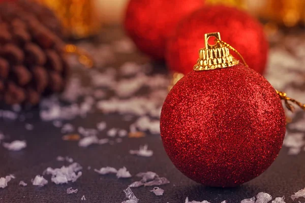 Red satin Christmas ball on black — Stock Photo, Image