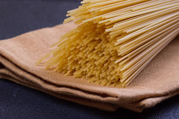 Uncooked pasta on a cloth — Stock Photo, Image