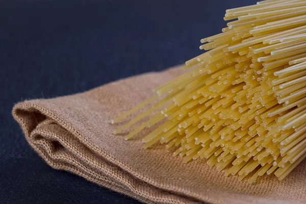 Uncooked pasta on a cloth — Stock Photo, Image