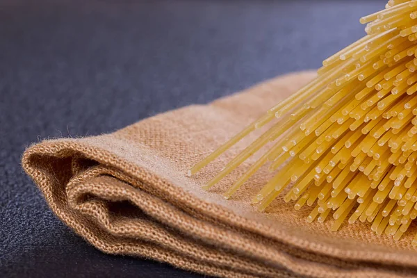 Uncooked pasta on a cloth — Stock Photo, Image