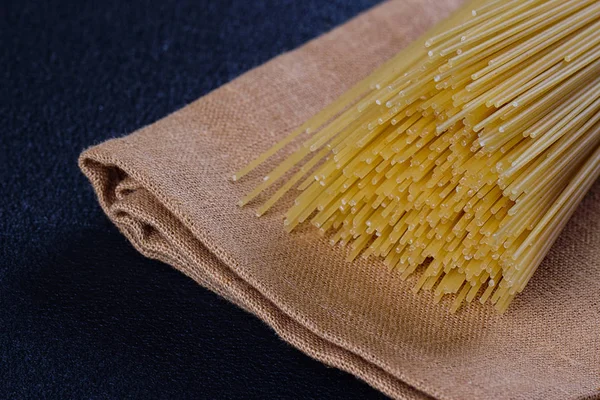 Uncooked pasta on a cloth — Stock Photo, Image