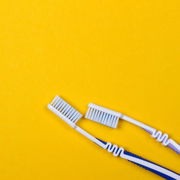 Two Toothbrushes on yellow background — Stock Photo, Image