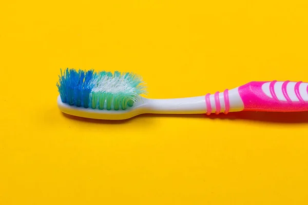 Toothbrushes on yellow background — Stock Photo, Image