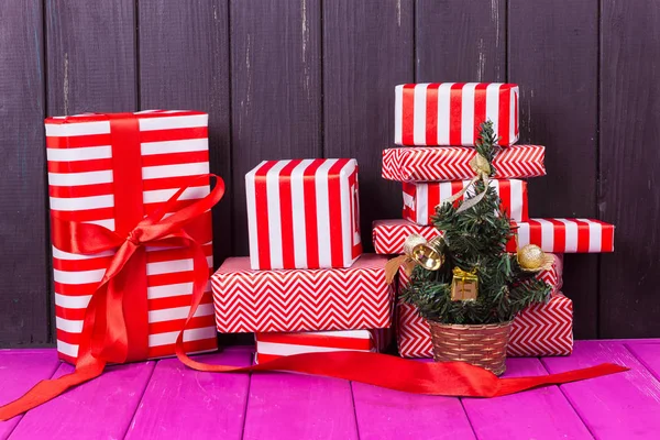 Gift boxes and small decorated Christmas tree — Stock Photo, Image