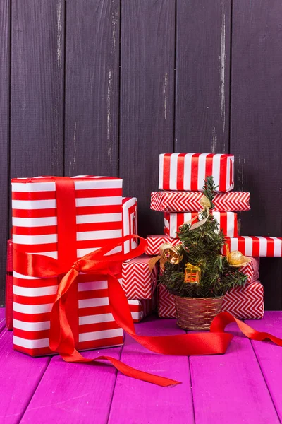 Gift boxes and small decorated Christmas tree — Stock Photo, Image