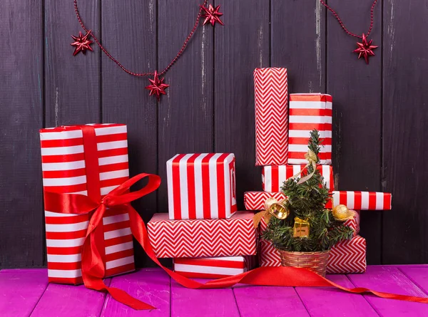 Gift boxes and small decorated Christmas tree — Stock Photo, Image