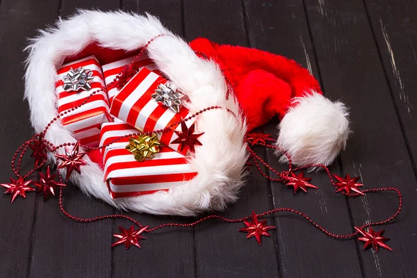 Christmas gifts in a Santa Claus hat — Stock Photo, Image