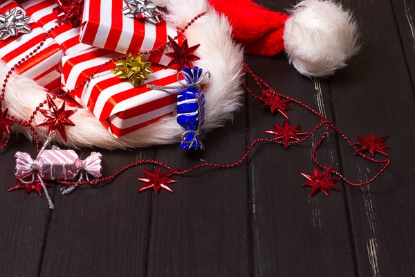 Christmas gifts in a Santa Claus hat — Stock Photo, Image