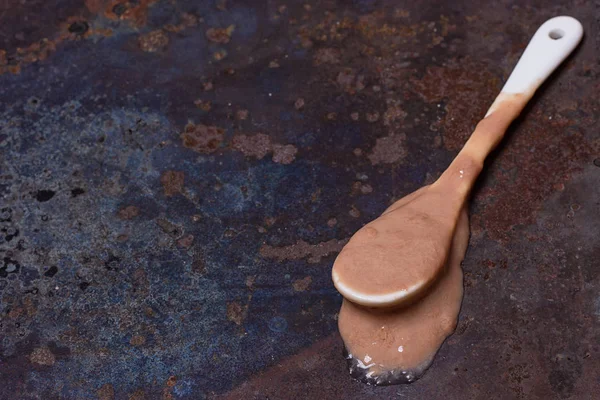 Spoon with melted ice cream — Stock Photo, Image