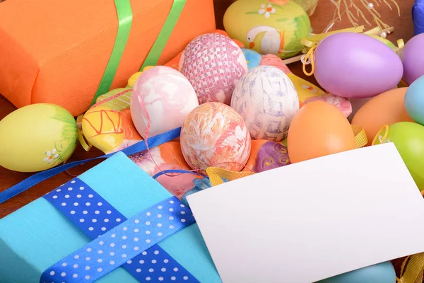 Arrangement of Gift Boxes in Wrapping Paper with Checkered Ribbons and Decorated Easter Eggs — Stock Photo, Image