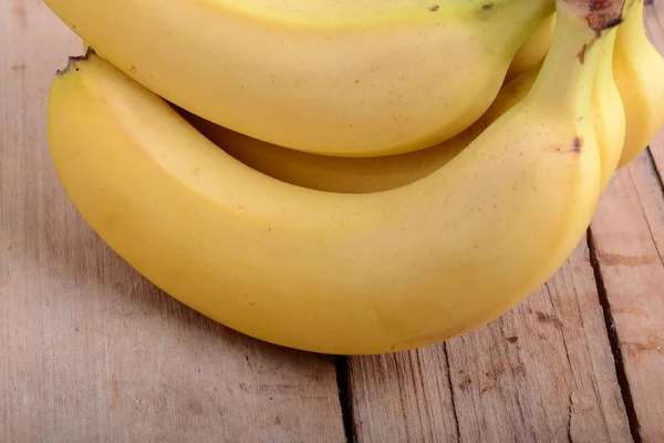 Massa gula bananer i en trä bakgrund — Stockfoto