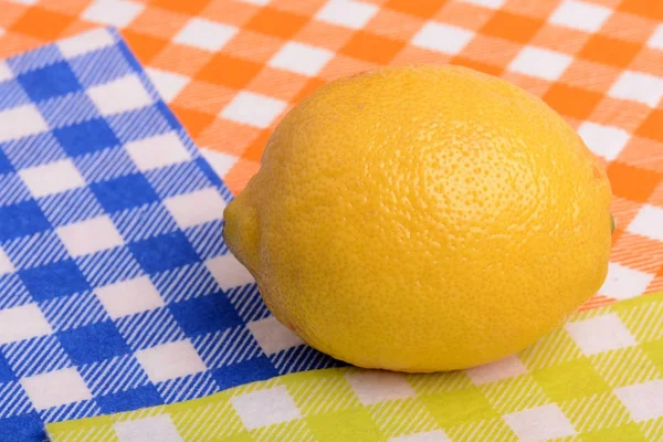 Fresh whole lemon on yellow blue and orange background — Stock Photo, Image