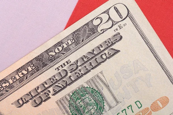 twenty dollar bill in front of the American flag