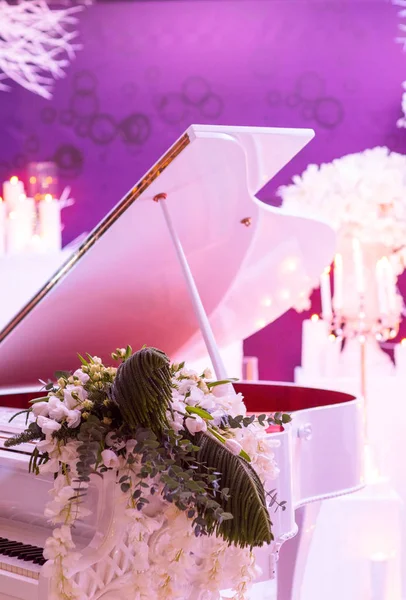 White grand piano and flower