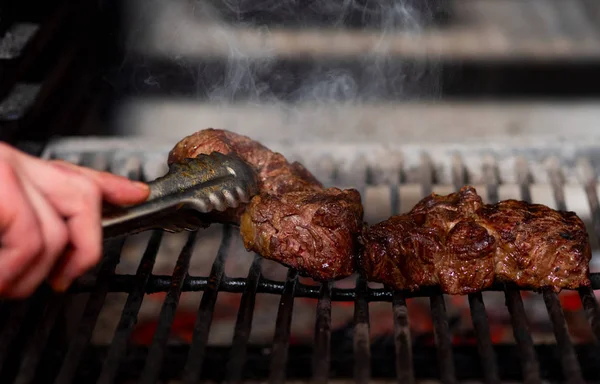 Steak meat is cooked on the fire — Stok fotoğraf
