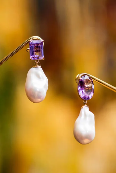 Lilac earrings on a blurry background — Stock Photo, Image