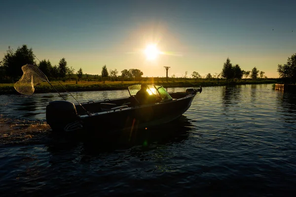Fisherman on a boat at dawn — Stock Photo, Image