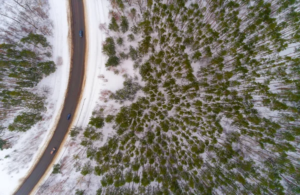 Highway and forest in winter aerial view — Stok fotoğraf