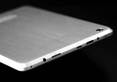 Beyaz arka planda geri uçan ince beyaz gümüş metal tablet