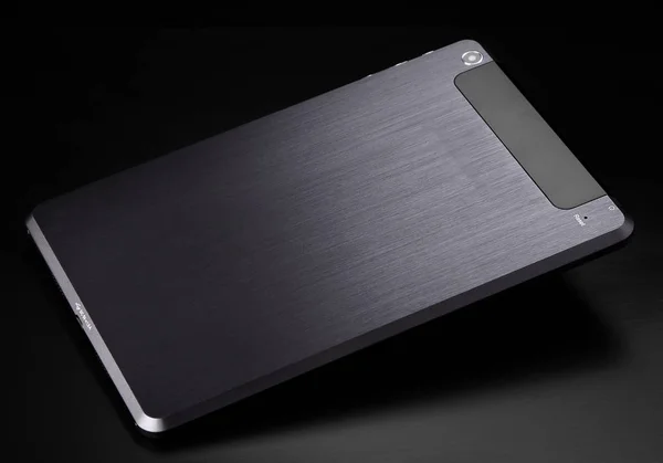 Tablet metal prata preta no fundo preto produto de volta plana — Fotografia de Stock