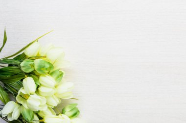 Beyaz ahşap masa arka plan üzerinde yalan bahar laleler