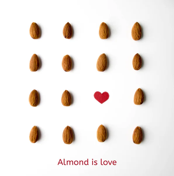 Nuts, almond, tasty and healthy food with lots of vitamins. Almond nuts placed in strick order with words Almond is love — Stock Photo, Image