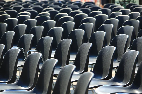 Black chairs outdoor row — Stock Photo, Image