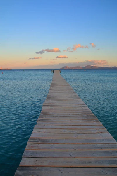 Wooden pier going to sea at sunset. — ストック写真