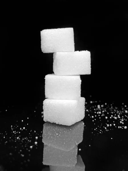 Sugar cubes, isolated on black background — Stock Photo, Image