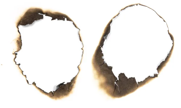 Buracos queimados em papel branco — Fotografia de Stock