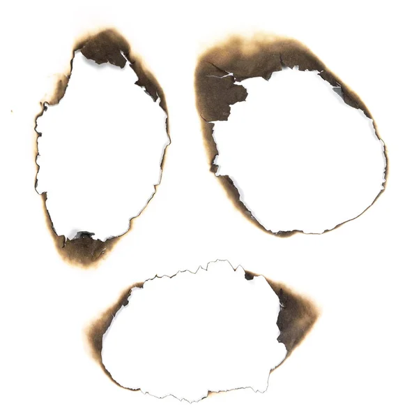Burned holes in white paper — Stock Photo, Image