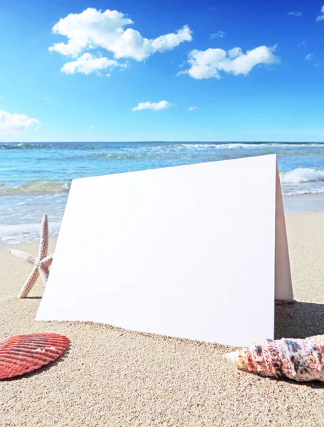 Tarjeta de felicitación blanca y en blanco en la playa —  Fotos de Stock