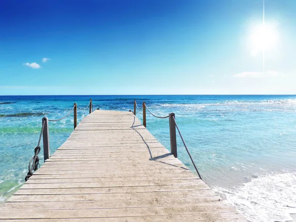 Gangplank into the sea with wooden planks — Stock Photo, Image