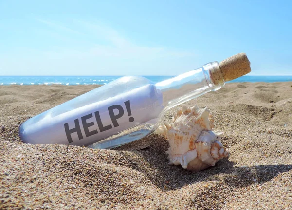 Message in a bottle with help letter — Stock Photo, Image