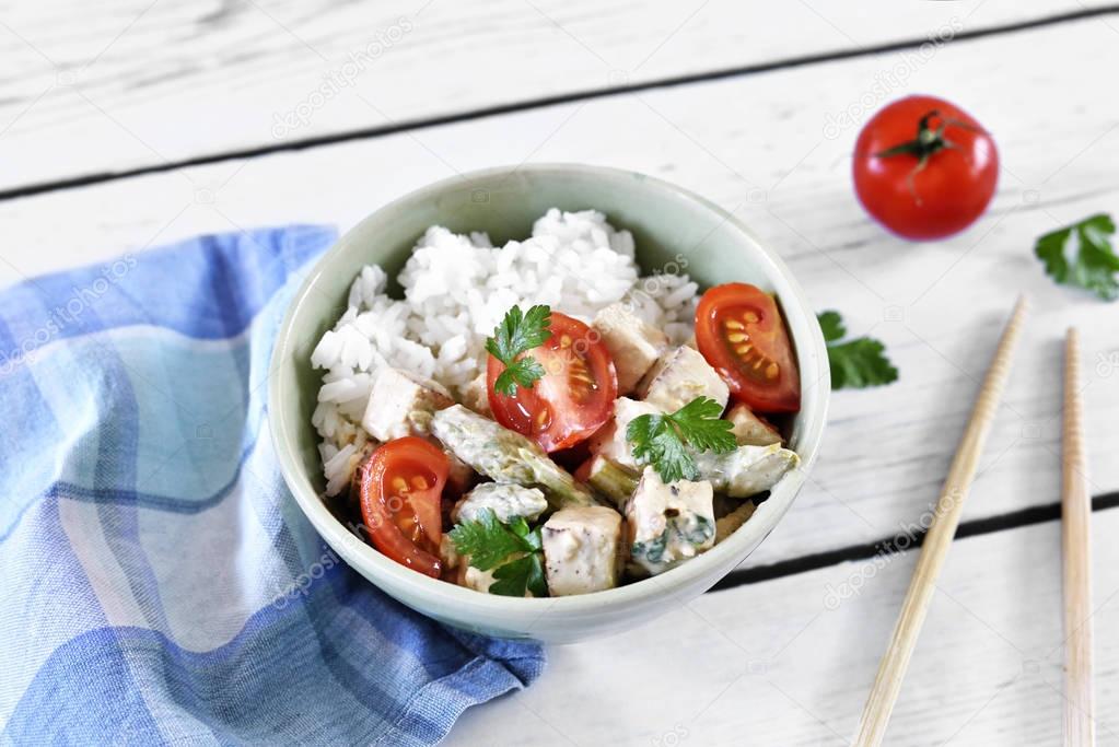 Delicious tofu dish with fresh tomatoes and green asparagus