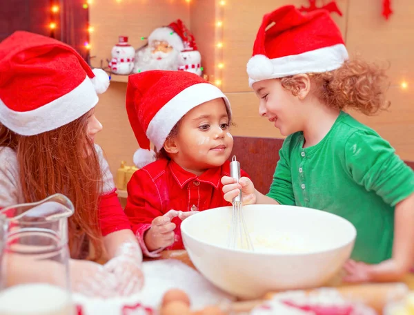 Three kids making Christmas cookies — Stock Photo, Image
