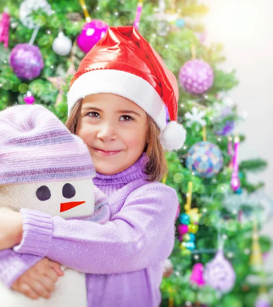 Little girl with snowman toy Royalty Free Stock Images