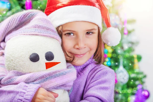 Little girl with snowman toy Royalty Free Stock Photos
