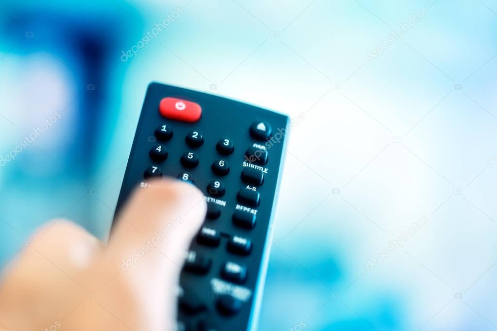 TV remote over blue screen background