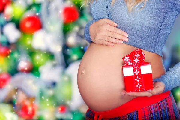 Pregnant woman with Christmas gift — Stock Photo, Image