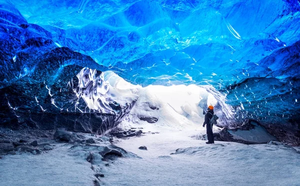 Traveler in ice cave — Stock Photo, Image