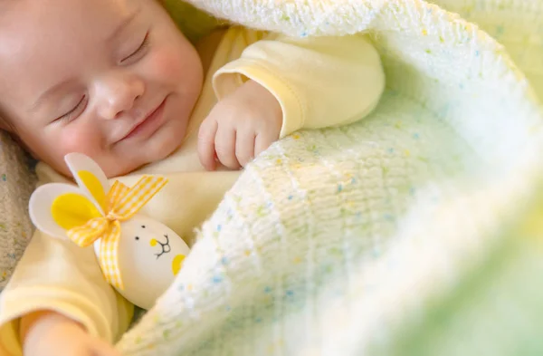 Cute baby sleeping with Easter decorations — Stock Photo, Image