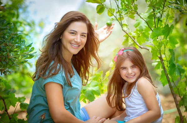 Mor med dotter i fruktträdgården — Stockfoto