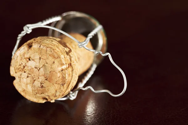 Cork of a sparkling wine on a dark leather