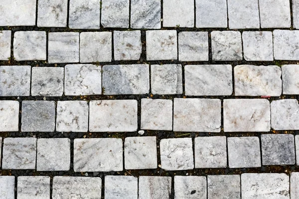 The granite cobbles creates bright sidewalk — Stock Photo, Image