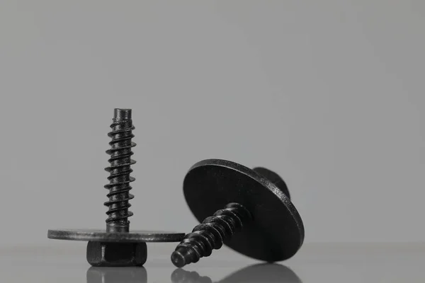 Two special black coated screws with washers — Stock Photo, Image