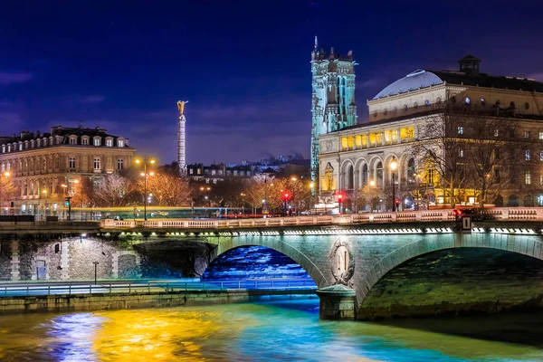 Twilight view onto the Seine at Pont au Change Bridge and Statue